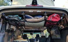 the back end of a van filled with luggage and other things to pack in it