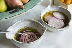 two bowls filled with onions and other vegetables