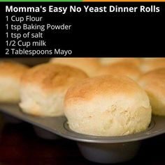 some bread rolls are on a metal tray and there is information about the different types