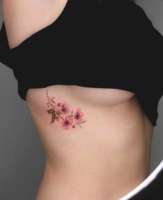 a woman's stomach with pink flowers on it