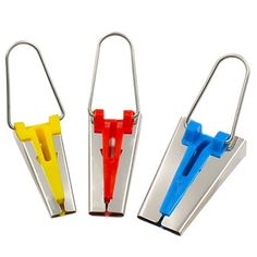 three different colored plastic clips in metal holders