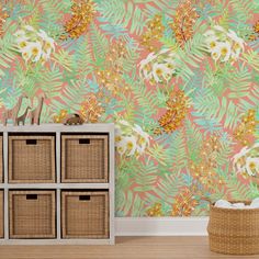 the wallpaper in this room is painted with tropical leaves and flowers, along with wicker baskets