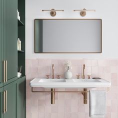 a white sink sitting under a mirror next to a green cabinet in a bathroom with pink tiles