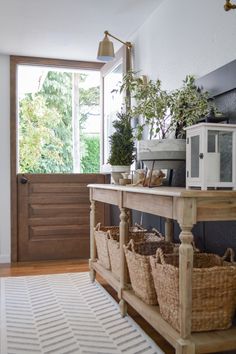 the entryway is decorated with baskets and plants