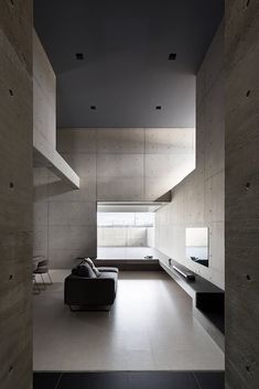 an empty living room with concrete walls and flooring is shown in this image, there are