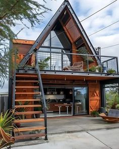 a house that is made out of wood and metal with stairs leading up to the roof