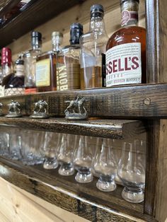 a shelf filled with lots of bottles and glasses