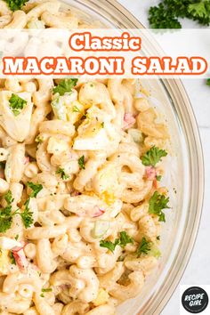 a bowl filled with macaroni salad and garnished with parsley