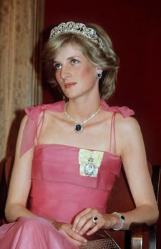 the princess of wales sitting in a chair wearing a tiara