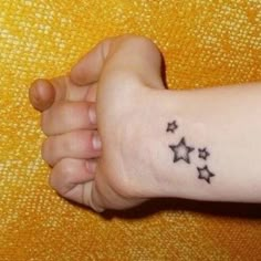 a person with a small star tattoo on their arm