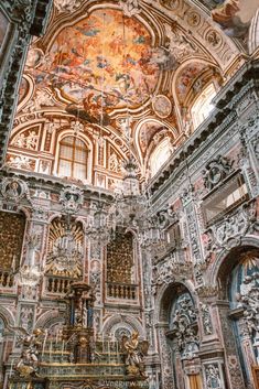 the interior of an ornate church with painted ceilings