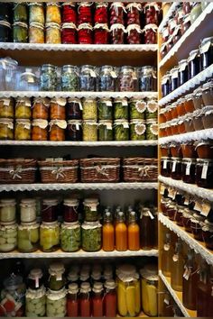 the shelves are filled with many different types of spices and condiments in glass jars