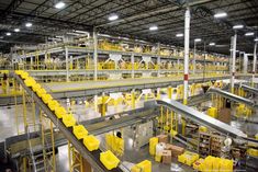 the inside of a large warehouse with lots of yellow boxes on it's sides