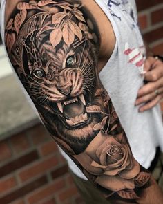 a man with a tiger and roses tattoo on his arm