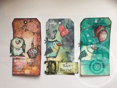 three tags with different designs on them sitting next to each other, one has balloons and the other has an owl