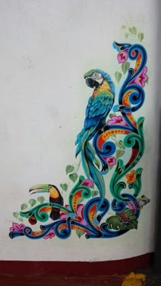 a colorful bird painted on the side of a building