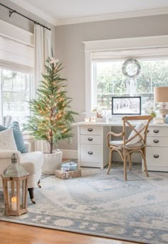 a living room filled with furniture and a christmas tree in the middle of the room