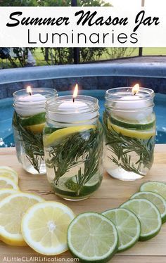 three mason jars filled with lemons, rosemary and water next to sliced limes