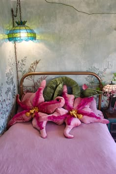 a bed with pink bedspread and flowers on it