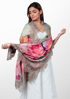 Immerse yourself in a world of romance and charm with this roses print scarf. The scarf features a delightful print of delicate roses, adding a touch of whimsy and elegance to your ensemble. Crafted from a blend of wool and silk, it offers a luxuriously soft and smooth feel against your skin. The scarf is further adorned with a sienna-colored floral lace border, showcasing intricate details and a graceful feminine flair. Wrap yourself in beauty and grace whilst keeping comfortably warm. Luxury Embroidered Silk Scarves, Elegant Multicolor Floral Print Shawl, Beauty And Grace, Roses Print, Gifted Hands, Lace Border, Rose Print, Scarf Print, Intricate Details