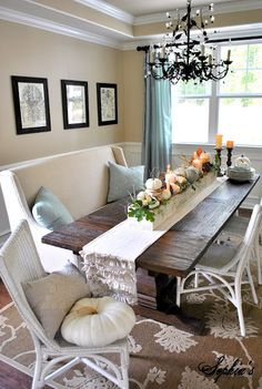 a dining room table with candles on it