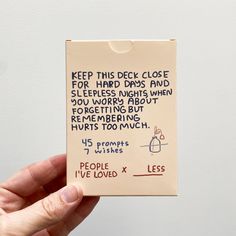 a hand holding up a piece of paper with writing on it that says keep this deck close for hard days and sleepless nights