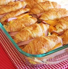 ham and cheese croissants in a casserole dish on a red checkered tablecloth