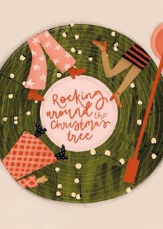 a green plate with an image of people in the background and words reading rocking around the christmas tree