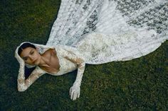 a woman laying on the ground in a white dress