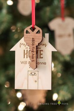 a wooden house ornament hanging from a christmas tree