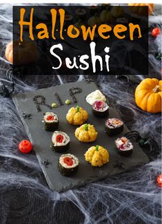 halloween sushi on a slate board with pumpkins in the background