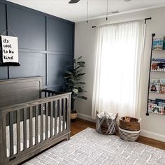 a baby's room with blue walls and white carpet