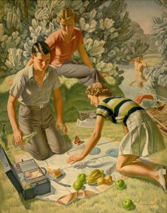 two women and a boy are preparing food on the grass in front of some trees