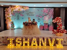 a stage set up for an event with balloons and flowers on the floor, decorated with letters that spell out'i shanve '