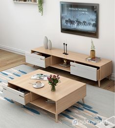 a living room with two coffee tables and a large tv mounted on the wall above it