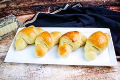 four croissants are on a white plate