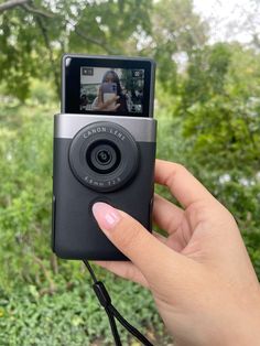 a person holding up a camera in their hand