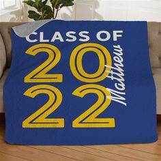 a blue and yellow throw blanket with the class of 2013 written on it