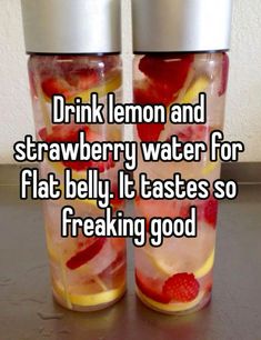 two water bottles with strawberries and lemons in them