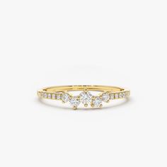 a yellow gold ring with three diamonds on it