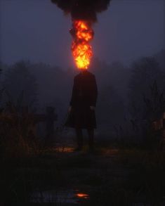 a man standing in the dark with flames coming out of his head