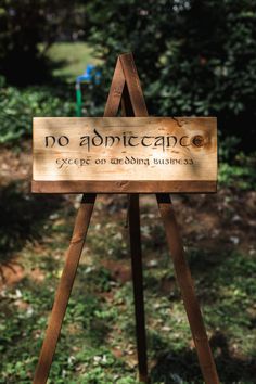 a wooden sign that says no admiticace except an abbing business on it