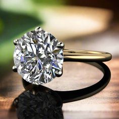 a diamond ring sitting on top of a wooden table