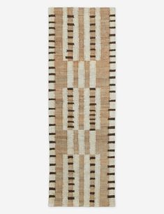 a beige and black striped rug on a white wall