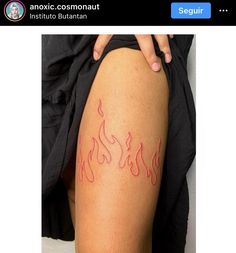 a woman's thigh with red flames on it and the words, antioxic cosmonuti