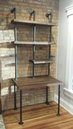 a room with a brick wall and two shelves on each side, one shelf has three metal pipes attached to it