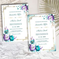 an ornate wedding card with purple and blue flowers on it, next to a palm leaf