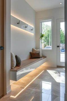 a hallway with a bench and two doors leading to the outside area is lit by sunlight coming through the window