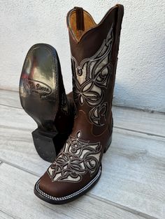 **DUE TO WIDE SQUARE TOE PLEASE ORDER HALF SIZE SMALLER** MADE IN MEXICO A true cowgirl boot, it features a genuine leather upper with fancy western embroidery. This boot utilizes an air mesh lining for excellent breathability without sacrificing quality, fit, or durability. This boots is sure to be one of your favorites, both in and out of the saddle. **DUE TO WIDE SQUARE TOE PLEASE ORDER HALF SIZE SMALLER** 1 1/2" heel height 11" shaft Western Glitter embroidery Lightweight, leather outsole Glitter Embroidery, Cute Cowgirl Boots, Cowboy Boots For Women, Western Embroidery, Brown Glitter, Womens Cowgirl Boots, Western Shoes, Cowgirl Boot, Embroidered Boots