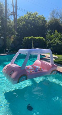 an inflatable car floating on top of a pool